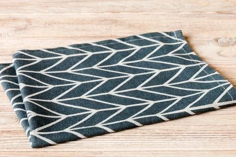 Top view with blue kitchen napkin isolated on table background. Folded clot.. Stock Photos