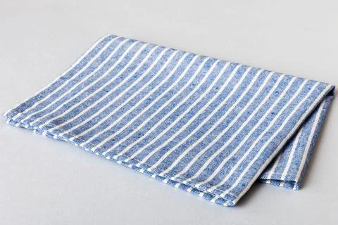 Top view with blue kitchen napkin isolated on table background. Folded clot.. Stock Photos