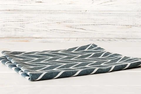 Top view with blue kitchen napkin isolated on table background. Folded cloth  Stock Photos