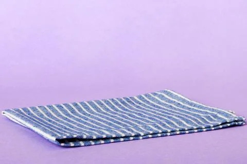 Top view with blue kitchen napkin isolated on table background. Folded clot.. Stock Photos