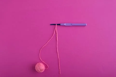 Top view of a blue shiny hook with a light purple plastic handle, on which a  스톡 사진