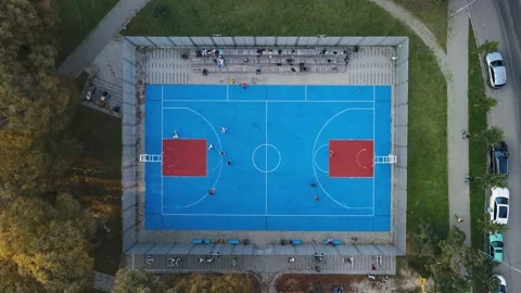 Top view of the blue stadium in the park, teenagers playing basketball Stock Footage 161121769