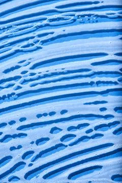 Top view of a blue surface covered with soap foam. Stock Photos