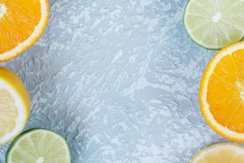 Top view of a blue table with various cut citrus. Stock Photos