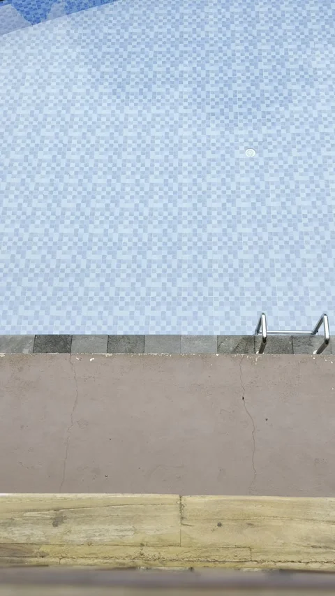 Top View of Blue Tiled Pool With Brown Deck Minimal Background Stock Footage 346281414