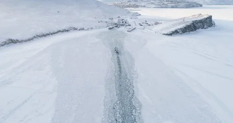 Top View Boat Float on the Surface of a Frozen Lake Baikal. Travel Concept Stock Footage 129422073