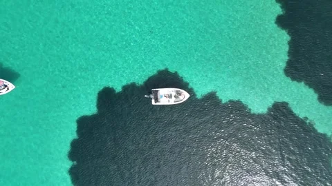 Top view of boat floating over crystal clear turquoise water, Greece Stock Footage 327723170