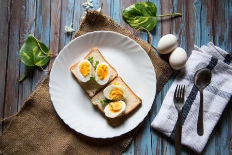 Top view of boiled eggs on bread slices in a plate Stock Photos