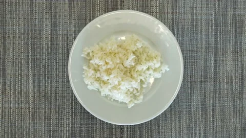 Top view, boiled rice. The plate rotates. Tasty and healthy food concept. Stock Footage 138926108