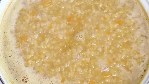 Top view of boiling red lentil soup Stock Footage 305251524