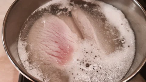 Top view of boiling water with meat broth. Cooking soup process. Boil poultry Stock Footage 266432985