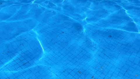 Top view on the bottom of the pool that is tiled and light ripples. Video stock 315509549