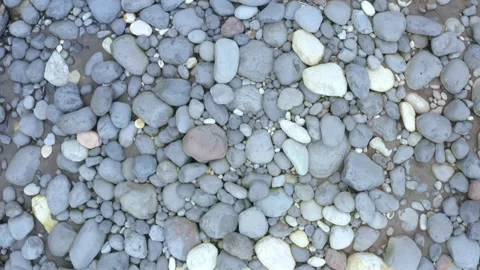 Top view of boulders and small pebbles found alongside a river Stock Footage 143676416