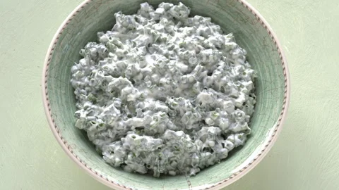 Top view of a bowl of dip made with Greek yogurt, chives, and salt. Stock-Footage 345087195