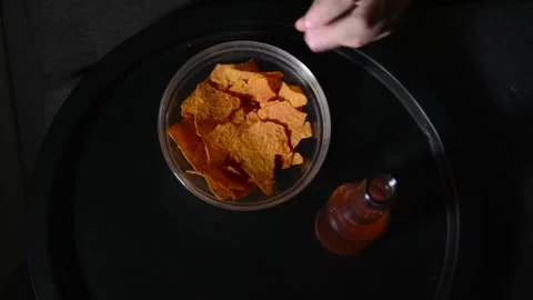 Top view of a bowl with tortilla chips and a bottle of kombucha Video stock 336505334