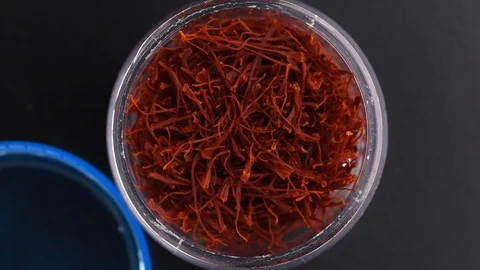 Top view box red saffron threads. Slowly rotating turntable black background. Stock Footage 128676140