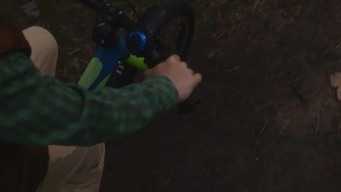 Top view of boy right hand and leg while cycling Stock Footage 316578837