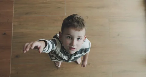 A top view of a boy trying to get something that is too high for him Vídeo Stock 122430227