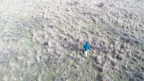 The top view of the boy who is running across the field Stock-Footage 86790007