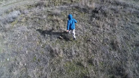The top view of the boy who is running across the field Stock Footage 86790026