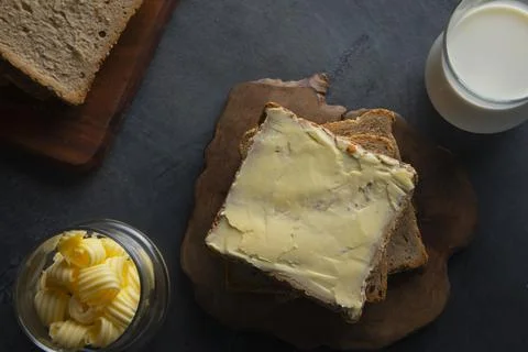 Top view of Bread and butter with a glass of milk	 Stock Photos
