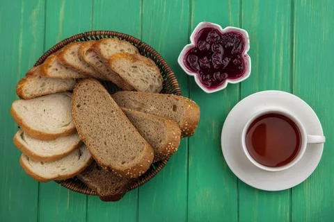 Top view of breads as seeded brown cob and baguette slices in basket and ra.. Stock Photos