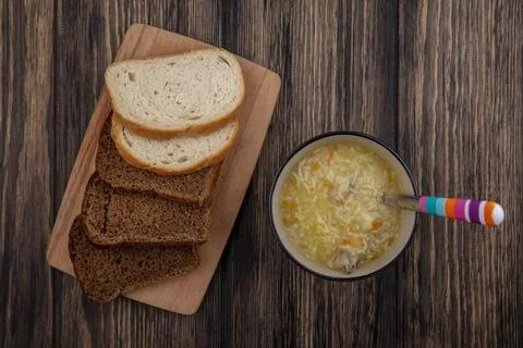 Top view of breads as sliced rye and white ones on cutting board and bowl o.. Stock Photos