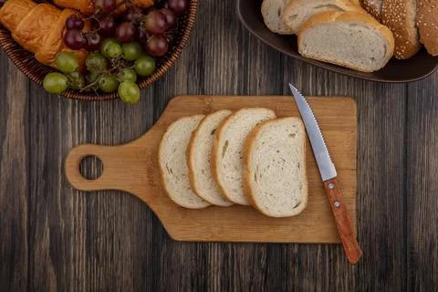 Top view of breads as sliced seeded brown cob and white ones in bowl and on.. Stock Photos