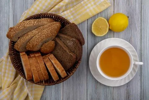 Top view of breads as sliced seeded brown cob rye and crusty ones in basket.. Stock Photos
