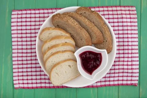 Top view of breads as sliced seeded brown cob and baguette ones with bowl o.. Stock Photos
