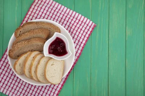Top view of breads as sliced seeded brown cob and baguette ones with bowl o.. Stock Photos