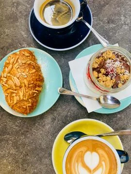 Top View Breakfast Flat Lay with Heart Latte Art, Almond Croissant and Yogu.. Photos