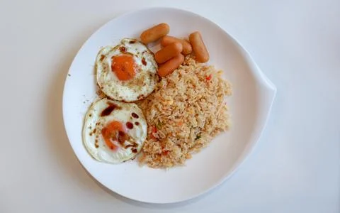 Top view of breakfast fried eggs with soy sauce and pepper, sausage Stock Photos