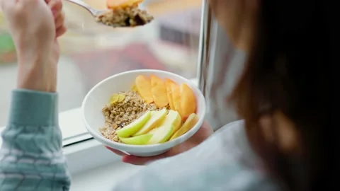 Top view for breakfast in the hands of an unrecognizable woman a spoon Stock Footage 225445593