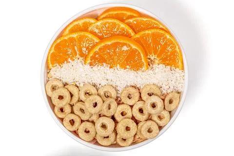 Top view, breakfast with multi-grain rings, tangerine pieces and coconut flak Stock Photos