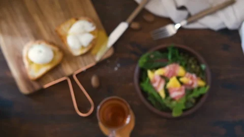 Top view of breakfast with poached egg and toast bread, salad with arugula Stock Footage 124796220