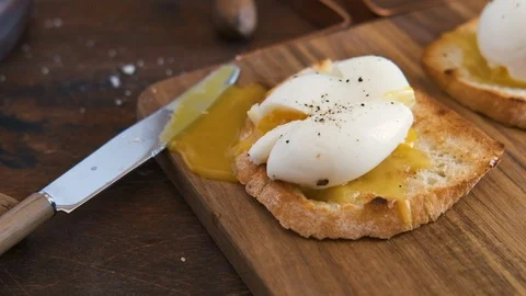 Top view of breakfast with poached egg and toast bread, salad with arugula Stock Footage 126485838