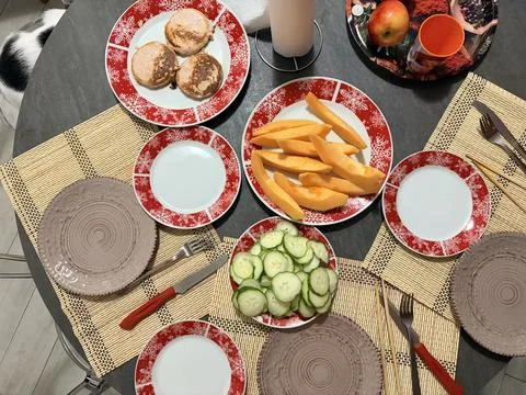 Top View of a Breakfast Table with Pancakes, Fresh Melon, and Sliced Cucumber Stock-Fotos