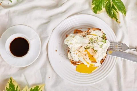 Top view Breakfast on white bed sheets, good morning, toast with poached eggs Stock Photos