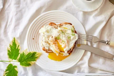 Top view Breakfast on white bed sheets, good morning, toast with poached eggs Stock Photos