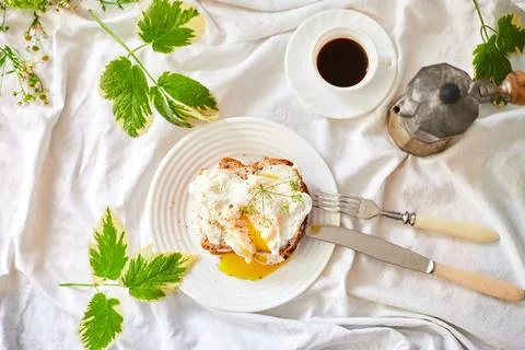 Top view Breakfast on white bed sheets, good morning, toast with poached eggs Stock Photos