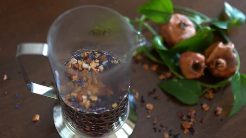 Top view of brewing herbal tea in teapot, mixture of dried pomegranate's fruits Stock Footage 128645004