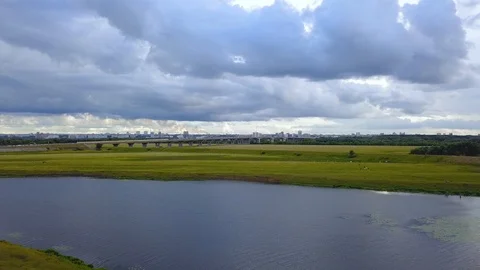 Top view bridge over river against summer landscape and city on horizon Stock Footage 97629507