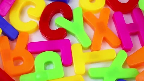 Top view of bright multicolored letters rotating as a background close up Stock Footage 236529737