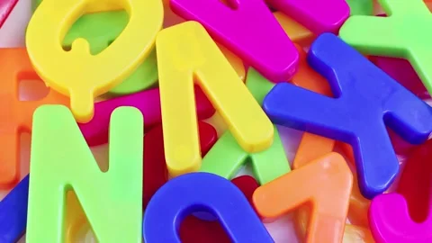 Top view of bright multicolored letters rotating as a background close up Stock Footage 237254750