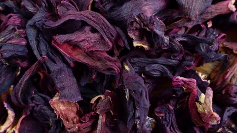 Top view of bright pink dried hibiscus tea leaves circle rotation close up Stock Footage 233500544