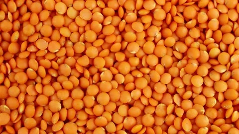 Top view of bright red lentils uncooked seeds circle rotation Stock Footage 233443942
