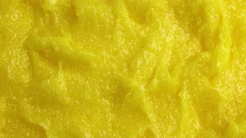 Top view of bright yellow lemon exfoliating sugar body scrub texture rotation Video stock 234780807