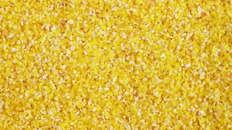 Top view of bright yellow small corn grits texture circle rotation close up Stock Footage 233996510