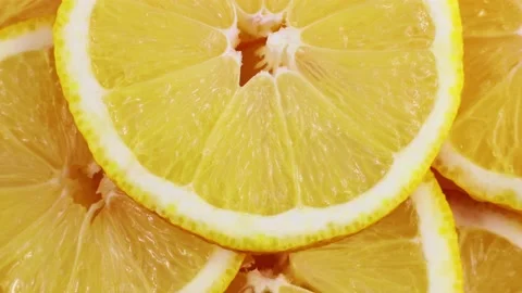 Top view of bright yellow sour lemon slices circle rotation close up Stock Footage 233098698
